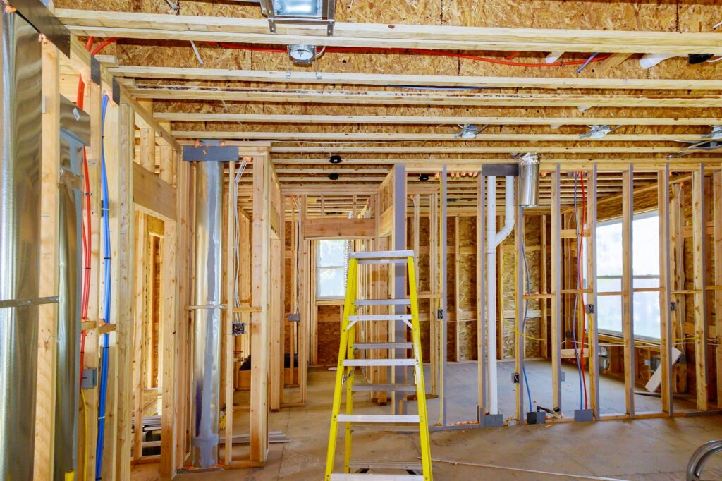 Home construction with hot red and cold blue pex pipe layout in pipes and exposed beams